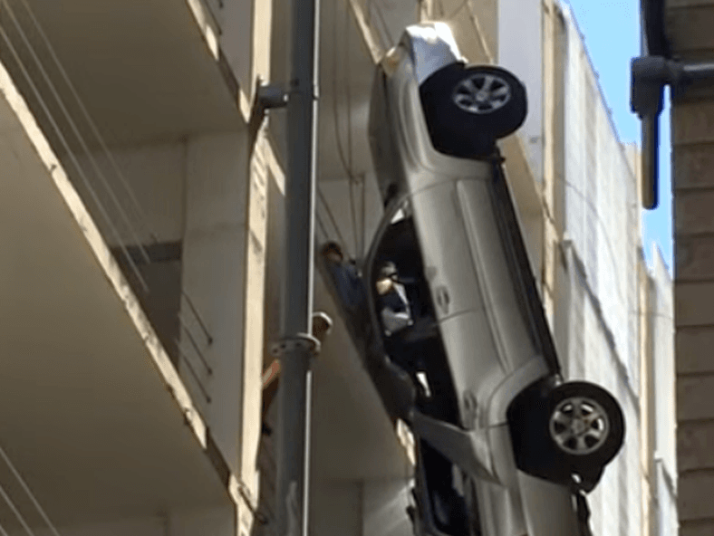 Vehicle Dangles From Parking Garage in Austin, Texas