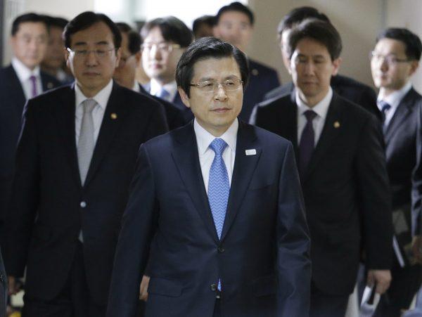 South Korean acting leader and Prime Minister Hwang Kyo-ahn, center, arrives to hold a press conference at the government complex in Seoul, South Korea on March 10, 2017. (Ahn Young-joon/AP Photo)