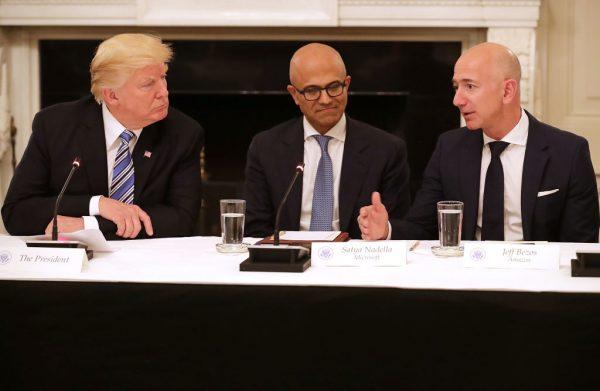 President Donald Trump, Microsoft CEO Satya Nadella, and Amazon CEO Jeff Bezos attend a meeting of the American Technology Council in the State Dining Room of the White House on June 19, 2017. (Chip Somodevilla/Getty Images)
