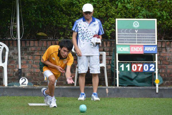 Wong Chun Yat (left in yellow) and Bronson Fung of Craigengower Cricket Club applaud a shot from their skipper during the league match against leader Hong Kong Football Club last weekend, September 23, 2017. The rink won the game comfortably and helped CCC to an 8-0 victory. (Stephanie Worth)