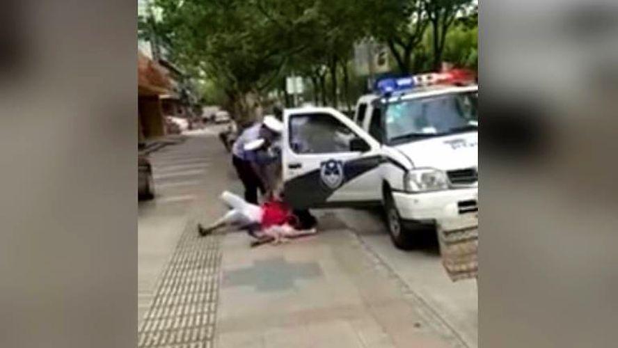Video of Chinese Police Officer Slamming Woman, Child Draws Ire