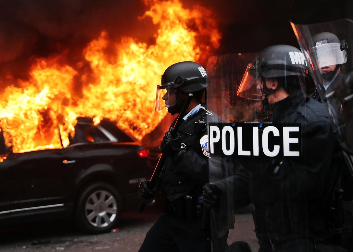 Police and demonstrators clash in downtown Washington after a limo was set on fire following the inauguration of President Donald Trump on Jan. 20, 2017, in Washington, D.C. (Spencer Platt/Getty Images)