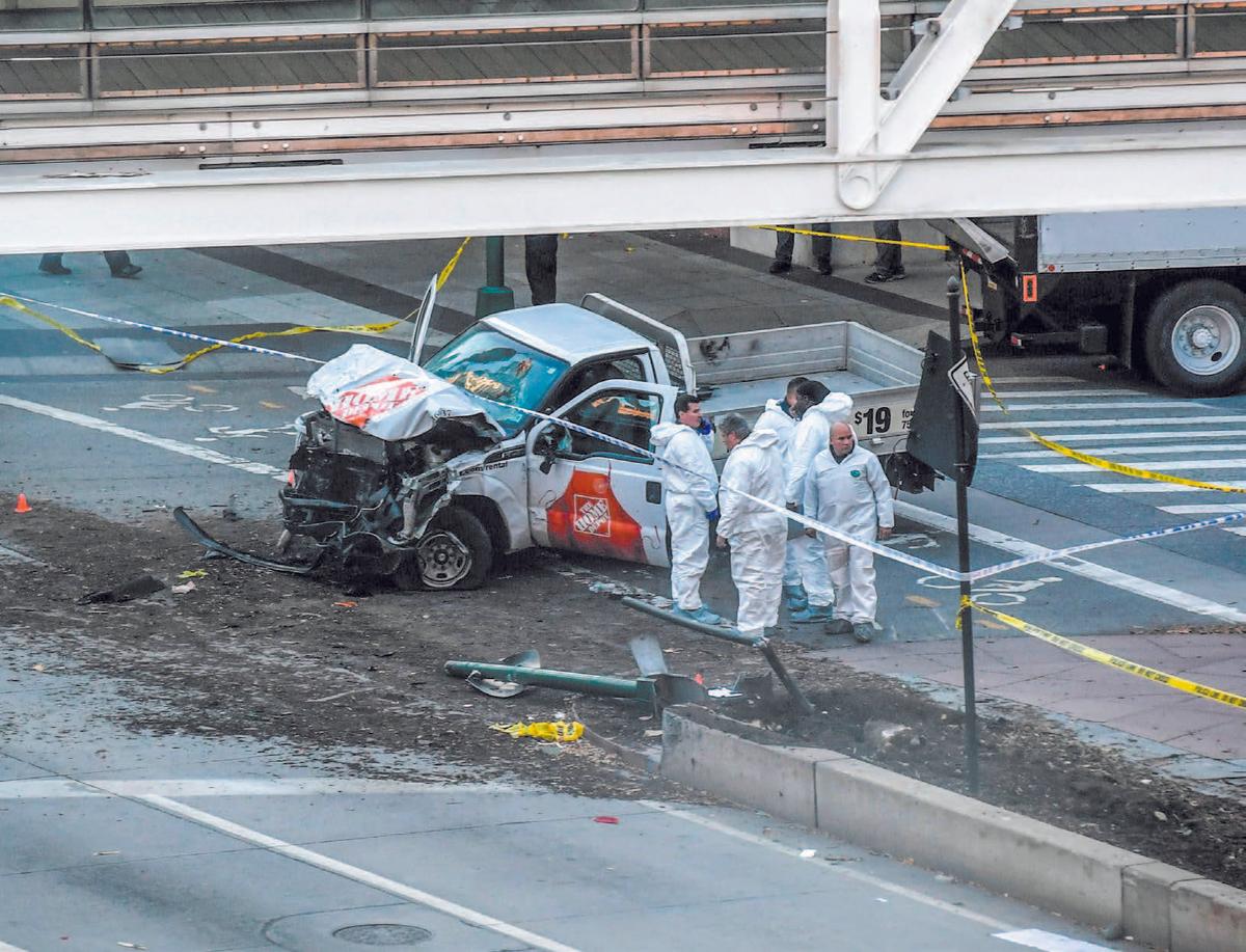 Investigators inspect a truck following the attack in New York on Oct. 31. (ALL PHOTOS BY DON EMMERT/AFP/GETTY IMAGES)
