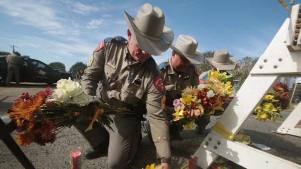 Police move flowers placed at a barricade near the First Baptist Church of Sutherland Springs in Sutherland Springs, Texas, on Nov. 6, 2017. (Scott Olson/Getty Images)