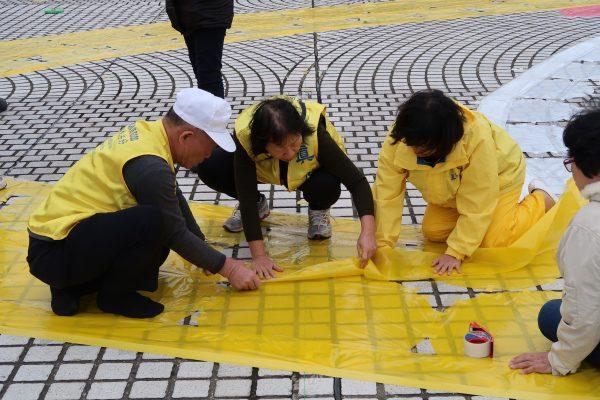 Practitioners of Falun Gong making preparation at Liberty Square in Taipei on Nov. 23, 2017. (Frank Fang/The Epoch Times)