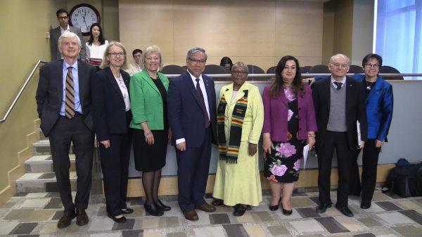 (L-R) Former Canadian MP and secretary of state for Asia-Pacific David Kilgour, Sen. Jane Cordy, Sen. Nancy Hartling, Sen. Thanh Hai Ngo, Sen. Wanda Thomas Bernard, Sen. Salma Ataullahjan, international human rights lawyer David Matas, and Sen. Kim Pate pose for a photo after a hearing on Bill S-240 at the Senate Human Rights Committee on May 23, 2018. (Limin Zhou/NTD Television)