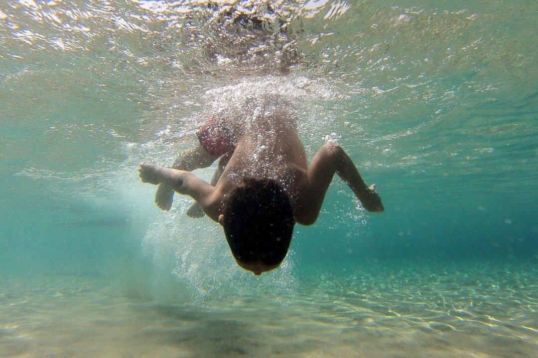 Drone Operator Yells at Swimming Boy Apparently Unaware of Sharks Nearby