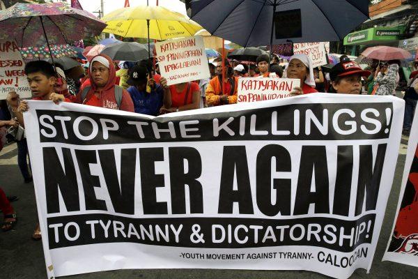 Protesters hold banners during a protest against President Rodrigo Duterte in Manila, Philippines, on Dec. 8, 2017. (AP Photo/Aaron Favila)