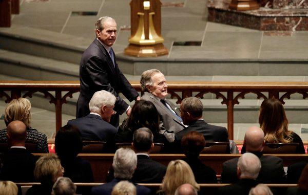 Former Presidents George W. Bush and George H.W. Bush arrive as they pass by former first lady Hillary Clinton (L to R), former President Bill Clinton, former first lady Michelle Obama, former President Barack Obama and first lady Melania Trump at St. Martin's Episcopal Church for a funeral service for former first lady Barbara Bush in Houston, Texas, on April 21, 2018. (David J. Phillip/Pool via Reuters)
