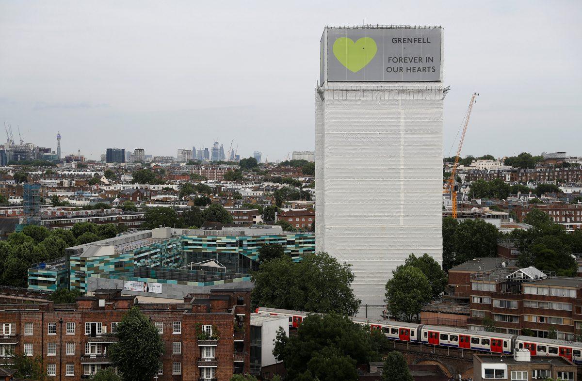Grenfell Tower is seen shrouded by scaffolding and covers one year after the tower fire in London, on June 13, 2018. (Peter Nicholls/Reuters)