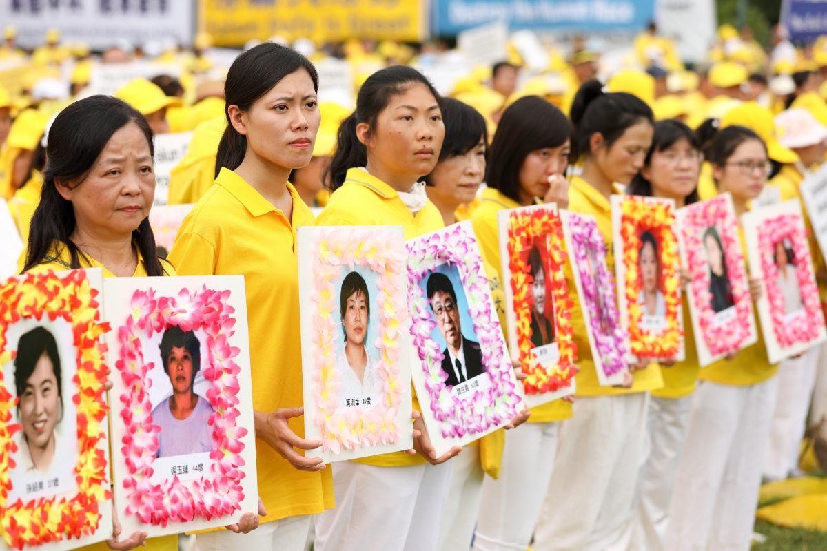 Falun Gong practitioners hold pictures of those who have been killed by the Chinese Communist Party through torture, during a march in Washington on June 20, 2018. (Edward Dye/Epoch Times)