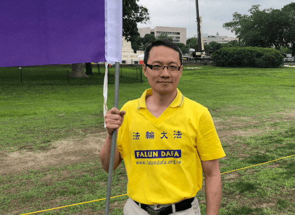 Chris Cheng joins the Falun Dafa march in Washington on June 20, 2018. (Nan Su/The Epoch Times)