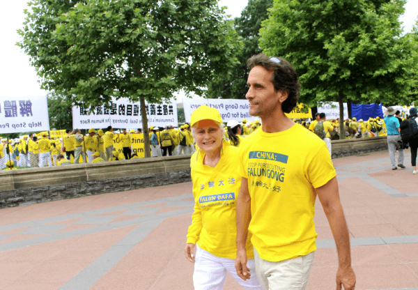 Joel Chipkar attends the Falun Dafa march in Washington on June 20, 2018, with his mother, Connie. (May Ning/The Epoch Times)