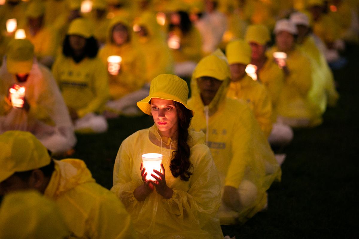 Falun Gong practitioners take part in a candlelight vigil to commemorate the practitioners killed in China for their belief, in Washington on June 22, 2018. (Benjamin Chasteen/The Epoch Times)