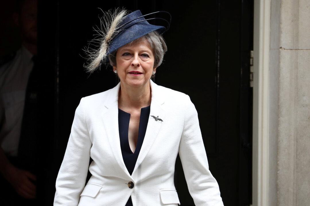 Britain’s May Reasserts Her Authority After Brexit Resignations