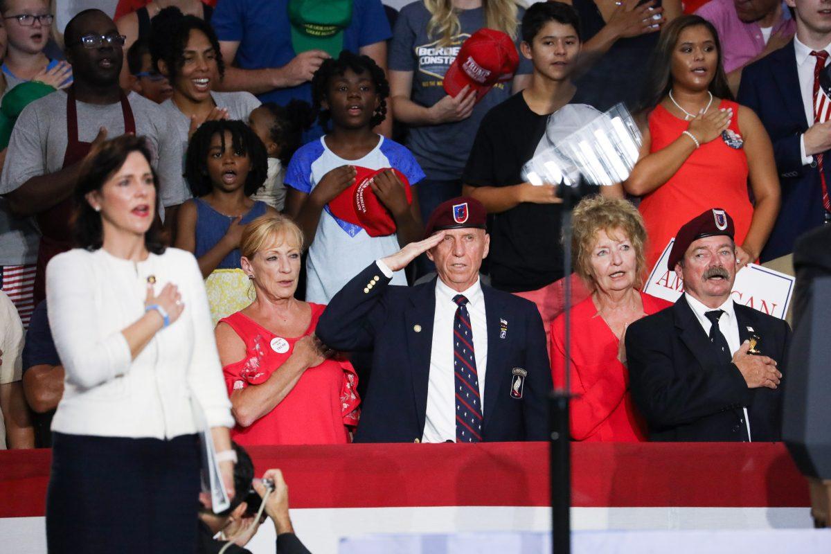 Jane Timken (L), chair of the Ohio Republican Party, stands for the national anthem at a Make America Great Again rally in Lewis Center, Ohio, on Aug. 4, 2018. (Charlotte Cuthbertson/The Epoch Times)