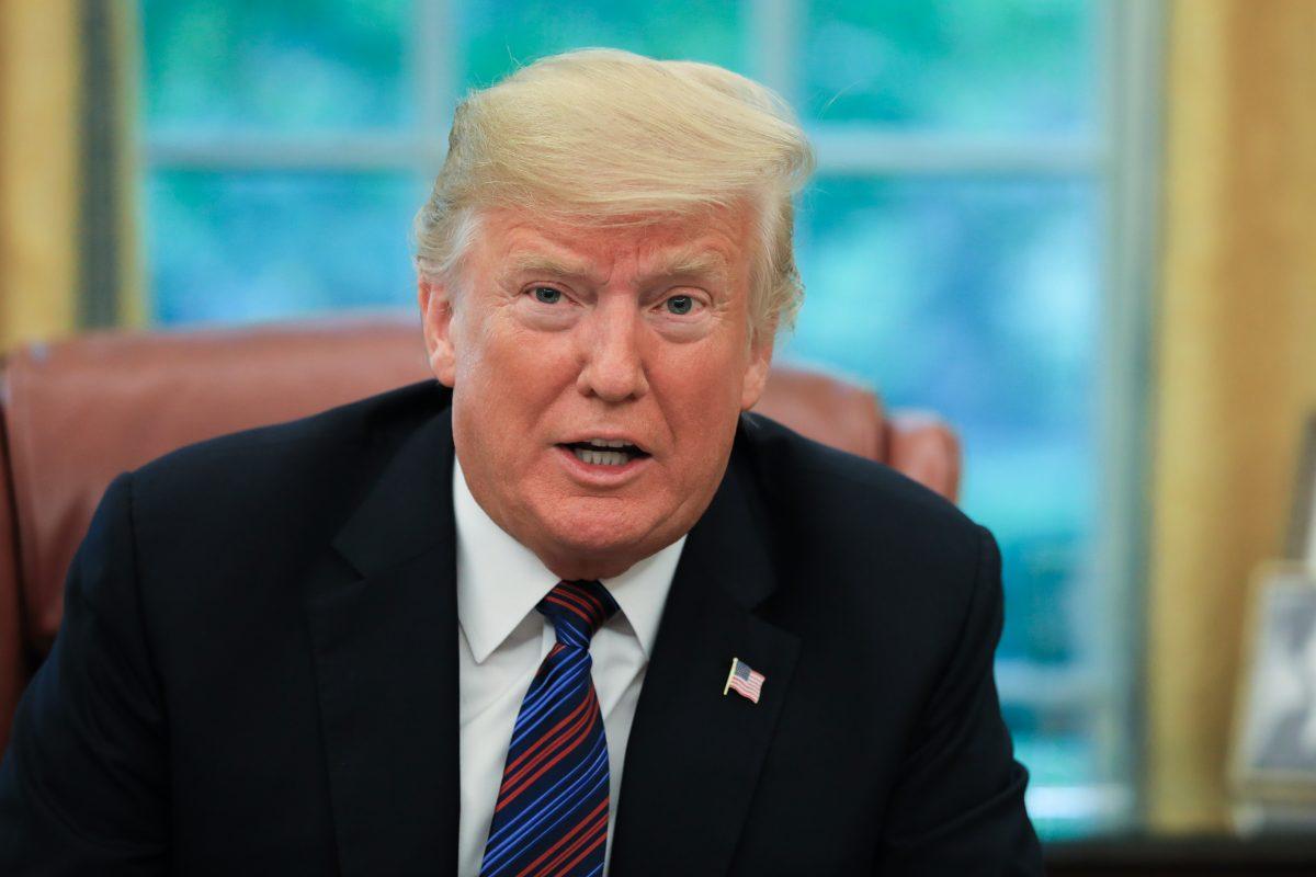 Then-President Donald Trump conducts a phone call in the Oval Office of the White House in Washington on Aug. 27, 2018. (Samira Bouaou/The Epoch Times)