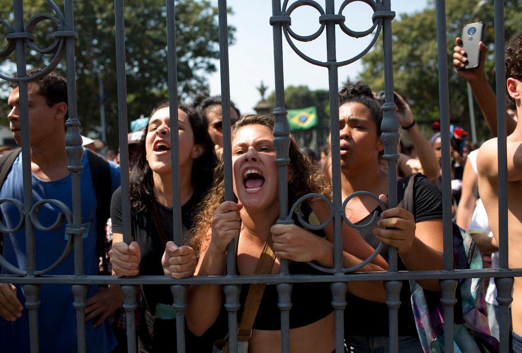 Students and National Museum employees protest outside the institution after it was gutted by an overnight fire in Rio de Janeiro, Brazil, Monday, Sept. 3, 2018. Recriminations flew over who was responsible for the loss of at least part of Latin America’s largest archive of historical artifacts, objects and documents. (AP/Silvia Izquierdo)