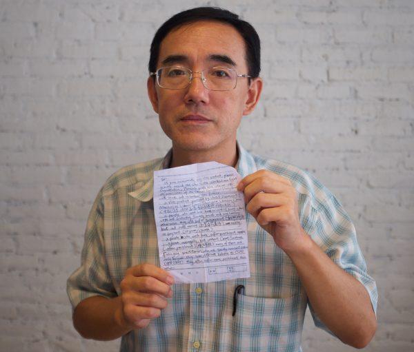 Sun Yi holding the SOS letter he wrote, which made its way around the world and back to him, in this undated photo. (Courtesy Flying Cloud Productions)