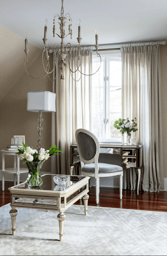 The Amelie Mirrored Console and a mirrored coffee table showcase his preference for art deco, while the vintage French side chair fulfills her love for the classics.