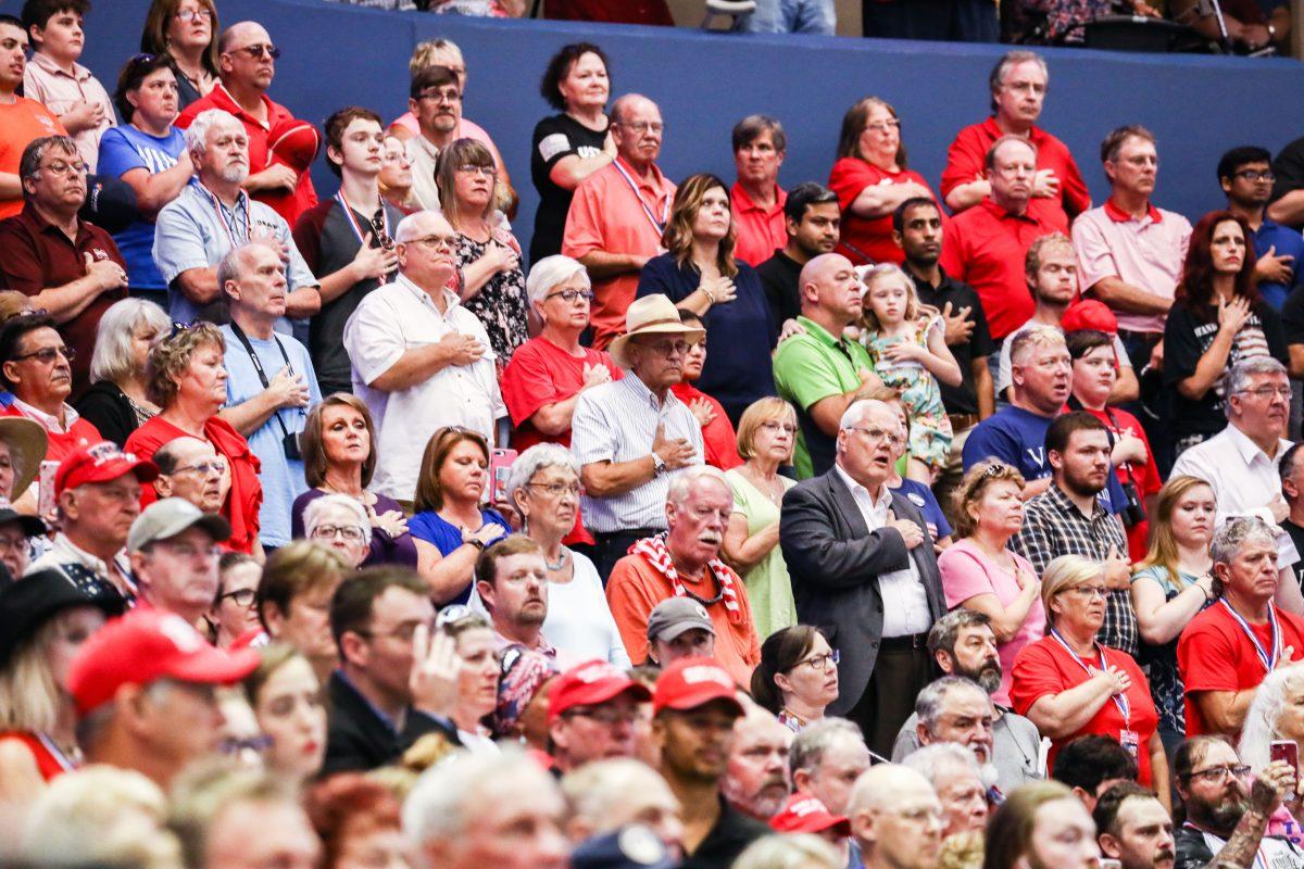 Attendees during the national anthem at a Make America Great Again rally in Southaven, Miss., on Oct. 2, 2018. (Charlotte Cuthbertson/The Epoch Times)