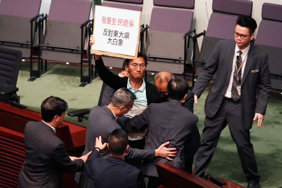 Some Hong Kong Lawmakers Walk Out of Policy Address Over Media ‘Persecution’