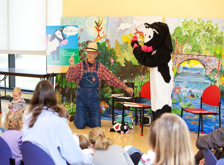 Man and Mascot Cow Spread Kindness to Kids