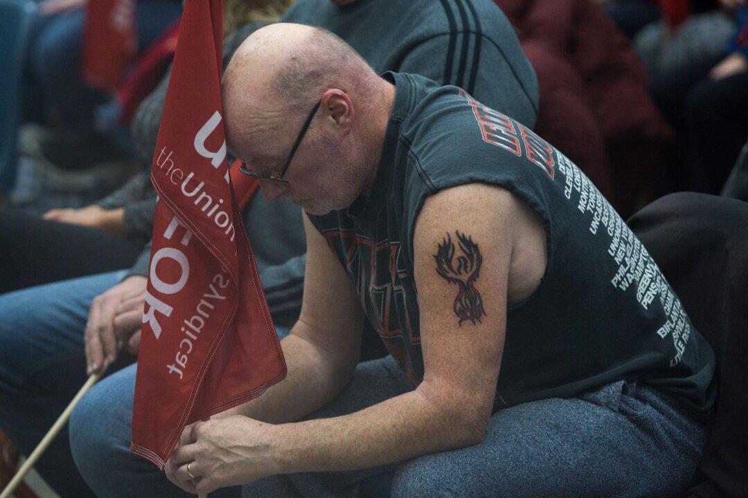 Emotional General Motors Workers Seen Wiping Away Tears After Company Lays Off 14,500 People