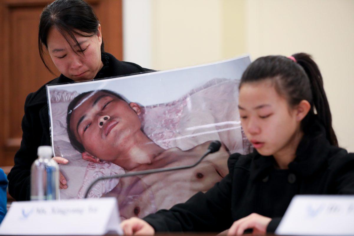 Xu Xinyang (R), a 17-year-old girl whose father (pictured) died as a result of the torture he endured in China because of his belief in Falun Gong, speaks at the Deteriorating Human Rights and Tuidang Movement in China forum, next to her mother Chi Lihua at Congress in Washington on Dec. 4, 2018. (Samira Bouaou/The Epoch Times)
