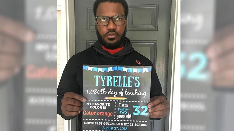 Sulky husband rolls his eyes as he poses for back-to-school pic with wife’s comical sign