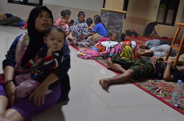 Residents sit inside a mosque as they evacuated following high waves and the eruption of Anak Krakatau volcano at Labuan district in Pandeglang regency, Banten province, Indonesia, Dec, 22, 2018. (Antara Foto/Muhammad Bagus Khoirunas/ via Reuters)