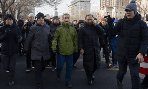 Yang Chunlin (C), a rights activist, shouts his support for detained Chinese human rights lawyer Wang Quanzhang before being arrested by plainclothes police in front of the number 2 intermediate people's court in Tianjin on December 26, 2018. (NICOLAS ASFOURI/AFP/Getty Images)
