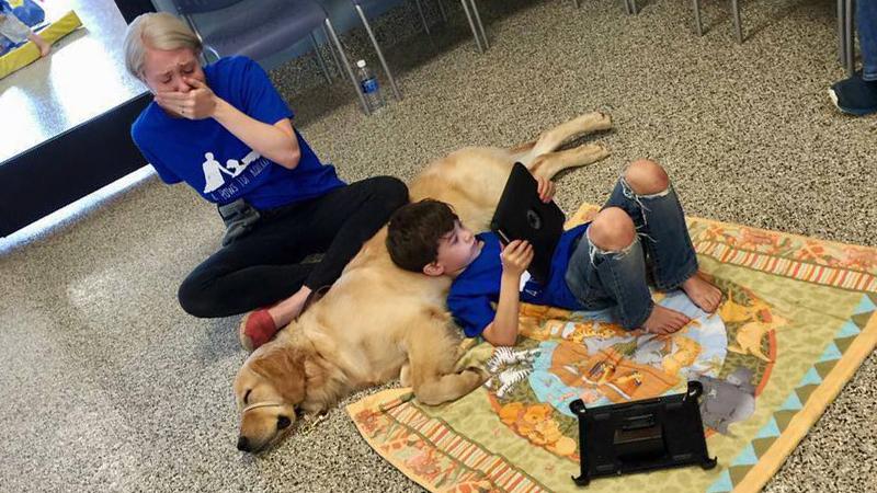 Crying Mom Silently Watches Her Son With Autism Cuddling a Service Dog
