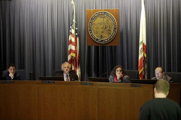 Michael Picker, President of the California Public Utilities Commission, second from left, listens to public comments with commissioners Martha Guzman Aceves, from left, Liane M. Randolph and Clifford Rechtschaffen during a meeting in San Francisco, on Jan. 28, 2019. (Jeff Chiu/AP Photo)