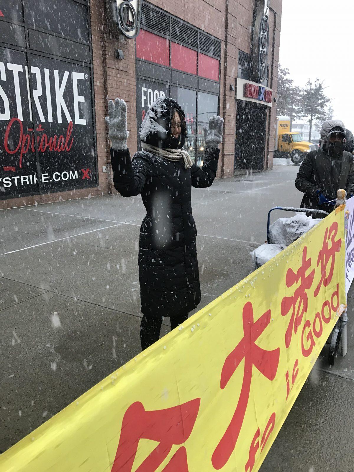 Han Yu practicing a Falun Gong exercise outside the Chinese embassy in New York with other practitioners. In front of them, the banner reads: "Falun Dafa is Good." (Courtesy of Han Yu)