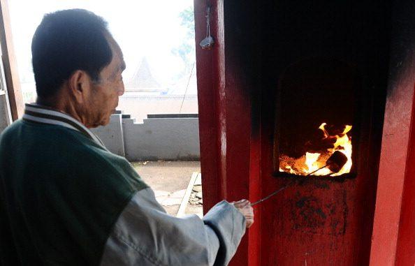 An Indonesian Chinese man performs a ritual during the pilgrimage to ancestor cemetery at Mount Kawi on Jan. 17, 2014 in Malang, Indonesia. (Robertus Pudyanto/Getty Images)