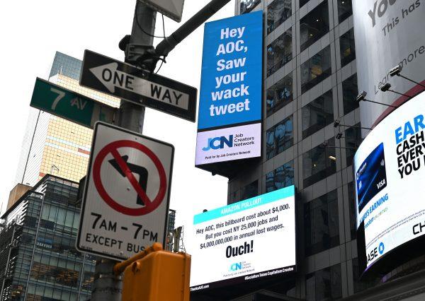 Job Creators Network called out Rep. Alexandria Ocasio-Cortez in signs on Times Square for the role it said she played in the recent termination of Amazon's HQ2, on Feb. 23, 2019. (Timothy A. Clary/AFP)