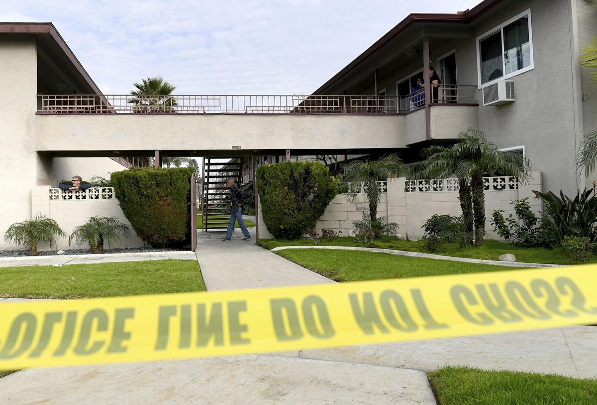 Residents mill about as Upland police investigate the scene in Upland, Calif., on Feb. 26, 2019. (Jennifer Cappuccio Maher/The Orange County Register via AP)