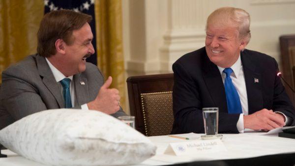President Donald Trump speaks with Mike Lindell (L), founder of MyPillow, during a Made in America event with US manufacturers in the East Room of the White House in Washington, on July 19, 2017. (Saul Loeb/AFP/Getty Images)