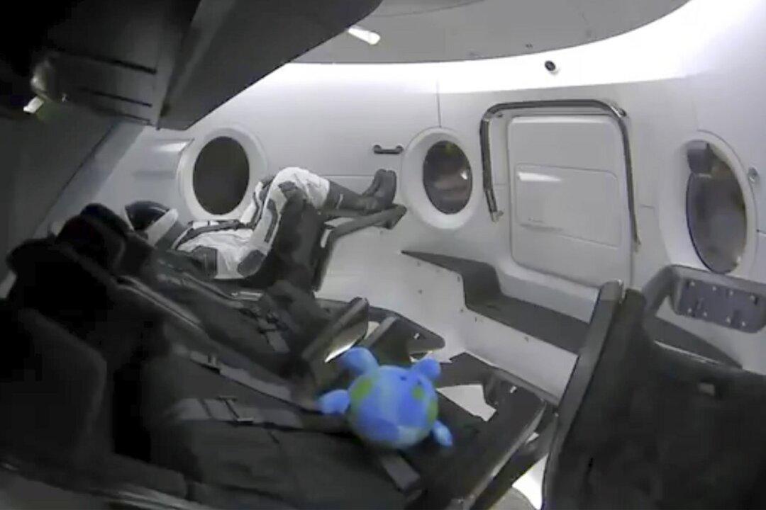 US-Built Capsule With a Dummy Aboard Docks at Space Station