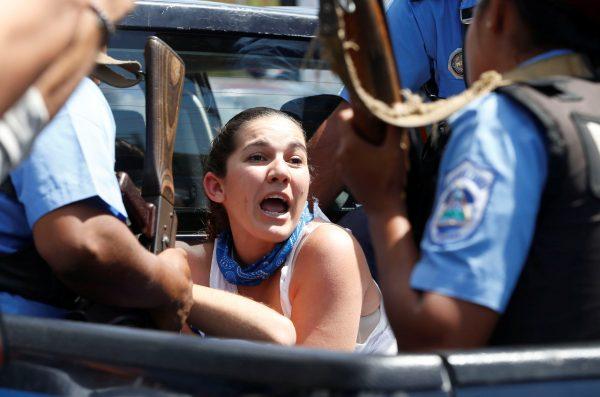 A demonstrator gestures as she is detained by riot police during a protest against the government of Nicaragua's President Daniel Ortega in Managua, Nicaragua March 16, 2019. (Oswaldo Rivas/Reuters)