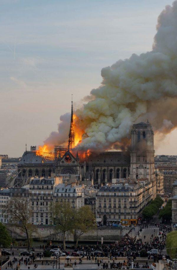 Smoke billows as flames burn through the roof of the Notre Dame cathedral on April 15, 2019, in the French capital Paris. (Fabien Barrau / AFP)
