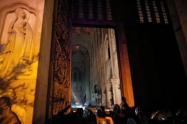 This general view from the entrance shows smoke rising in front of the altar cross at Notre Dame Cathedral in Paris, France, on April 15, 2019, after a fire engulfed the building. (Philippe Wojazer/AFP/Getty Images)