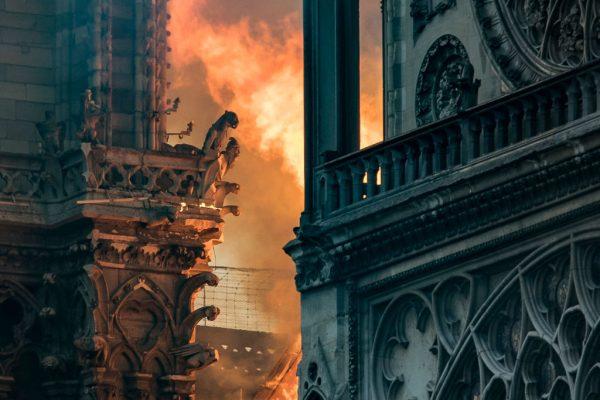 Flames and smoke billow around the gargoyles decorating the roof and sides of the Notre-Dame Cathedral in Paris, France, on April 15, 2019. (Thomas Samson/AFP/Getty Images)