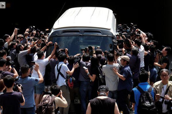Photographers take pictures of four jailed leaders of the 2014 pro-democracy "Occupy" movement at the court in Hong Kong, China on April 24, 2019. (Tyrone Siu/Reuters)