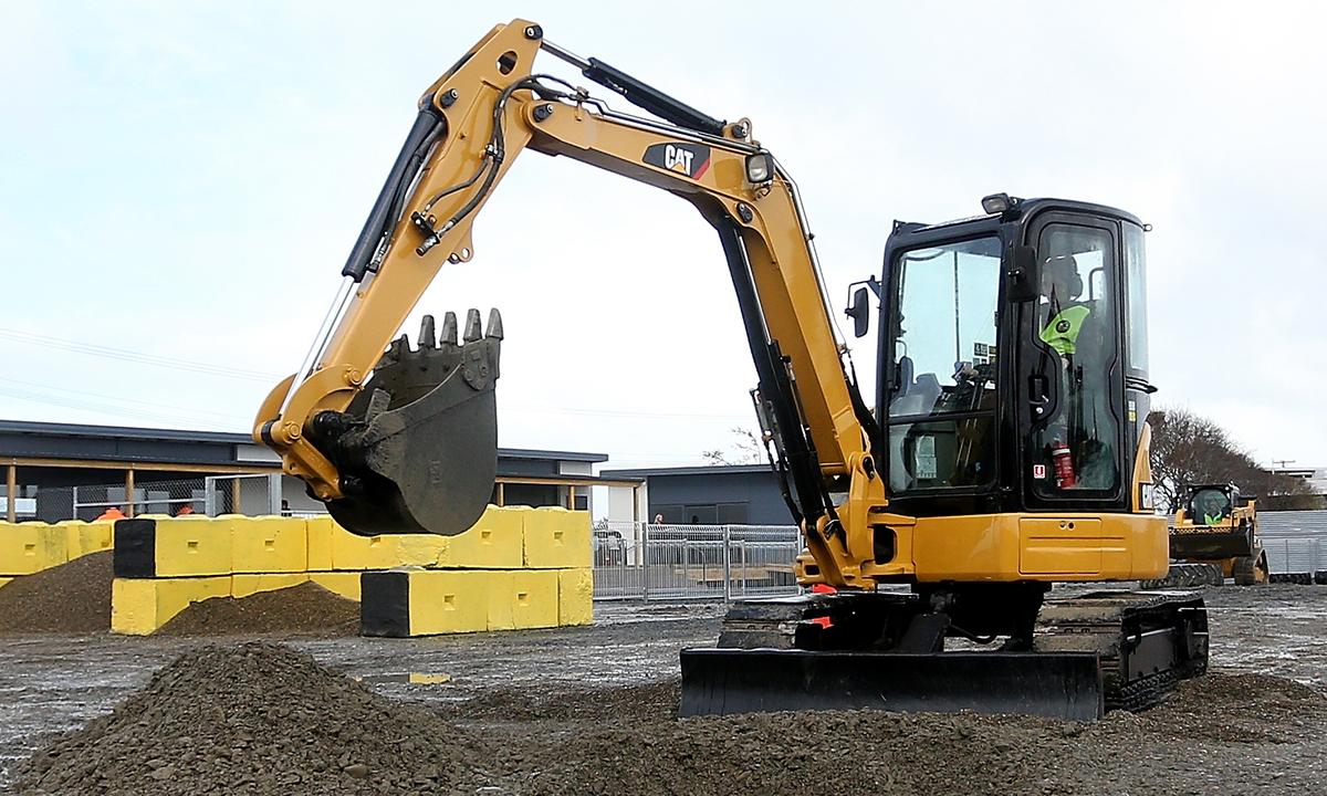 Father Leads 3-Year-Old Boy to Drive Construction Vehicle on Public Road