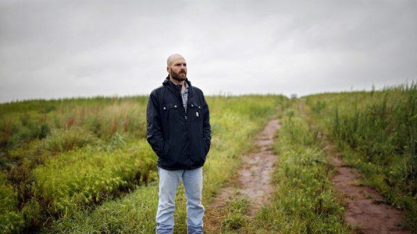 Michael Behenna stands on land that he helps work in Medford, Okla., on July 17, 2014. (Sarah Phipps/The Oklahoman via AP)