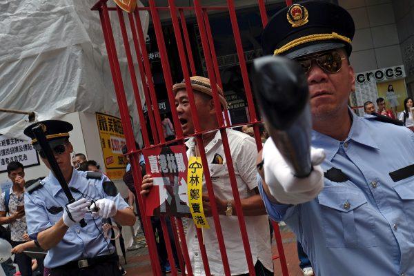 Protesters dressed as Chinese police during a protest to demand authorities scrap a proposed extradition bill with China, in Hong Kong, China on April 28, 2019. (Tyrone Siu/Reuters)