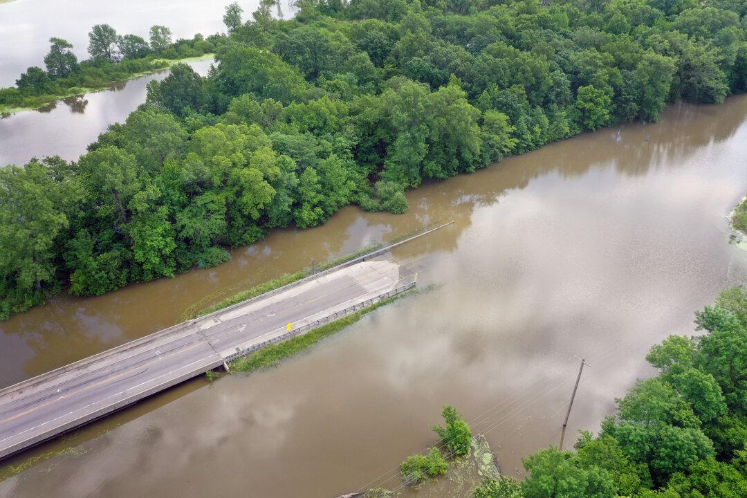 Hundreds of Roads Under Water as Historic Flooding Breaches Levees and Threatens Communities