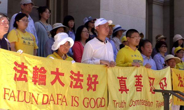 Supporters of Falun Gong holding banners on the steps of the California Capitol Building in Sacramento, June 11, 2019. (Daniel Holl/The Epoch Times)